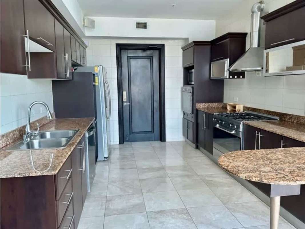 Modern kitchen with granite countertops, dark cabinetry and appliances PH Miramar Panama