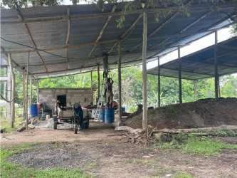 Covered utility shed with materials and machinery on farm in Coclé Panama