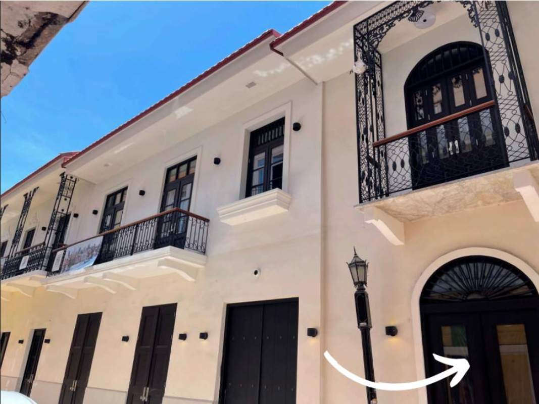 Cream colonial facade with black balconies and tile roof Casco Viejo Santa Familia Panama