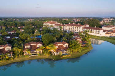 Aerial view of waterfront Mediterranean-style villas within lush resort in Buenaventura Panama