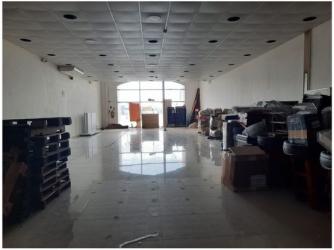 Warehouse storage area with pallets boxes and tiled floor inside Farallones Penonomé