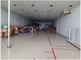 Commercial warehouse interior with high ceiling storage racks pallets Farallones Plaza Penonomé