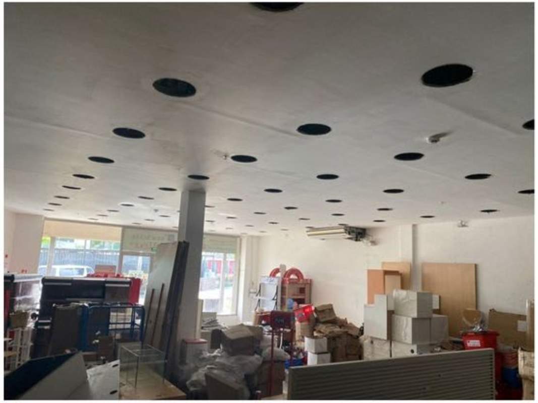 Interior view commercial retail space with lighting cutouts wall-mounted AC Plaza Nuevo Tocumen Panama