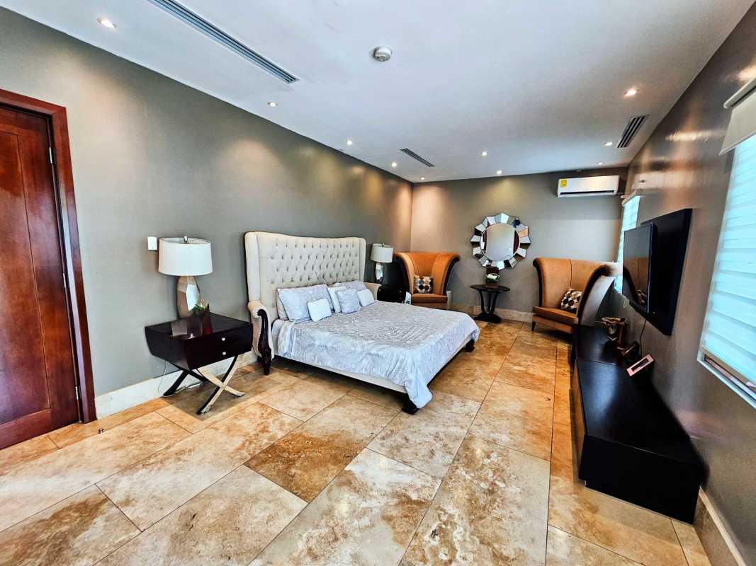 Mediterranean style covered patio overlooking gardens and pool in Santa María Panama Golf community