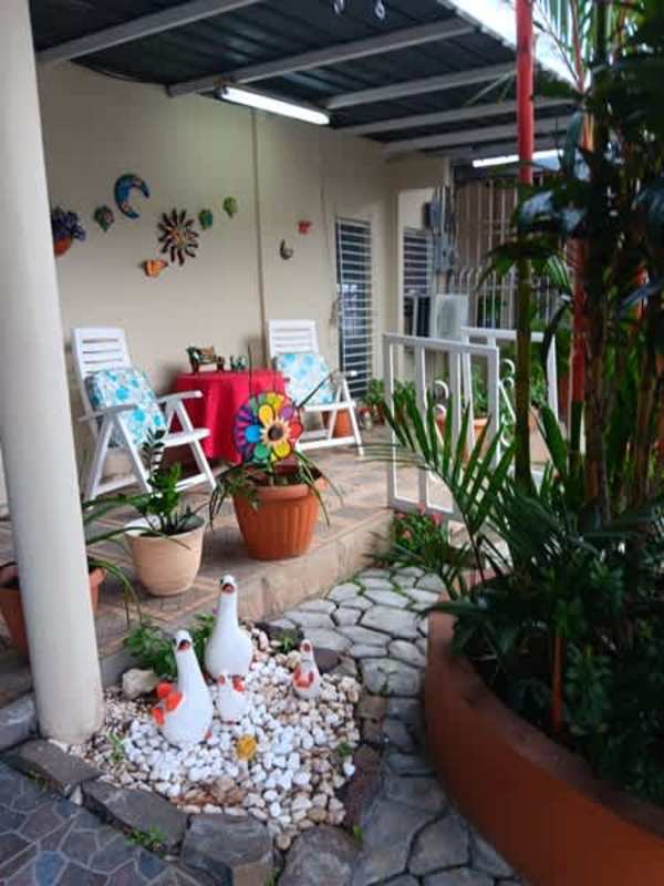 Kitchen with green trim, dining table, gas stove in San Antonio Panama house for sale
