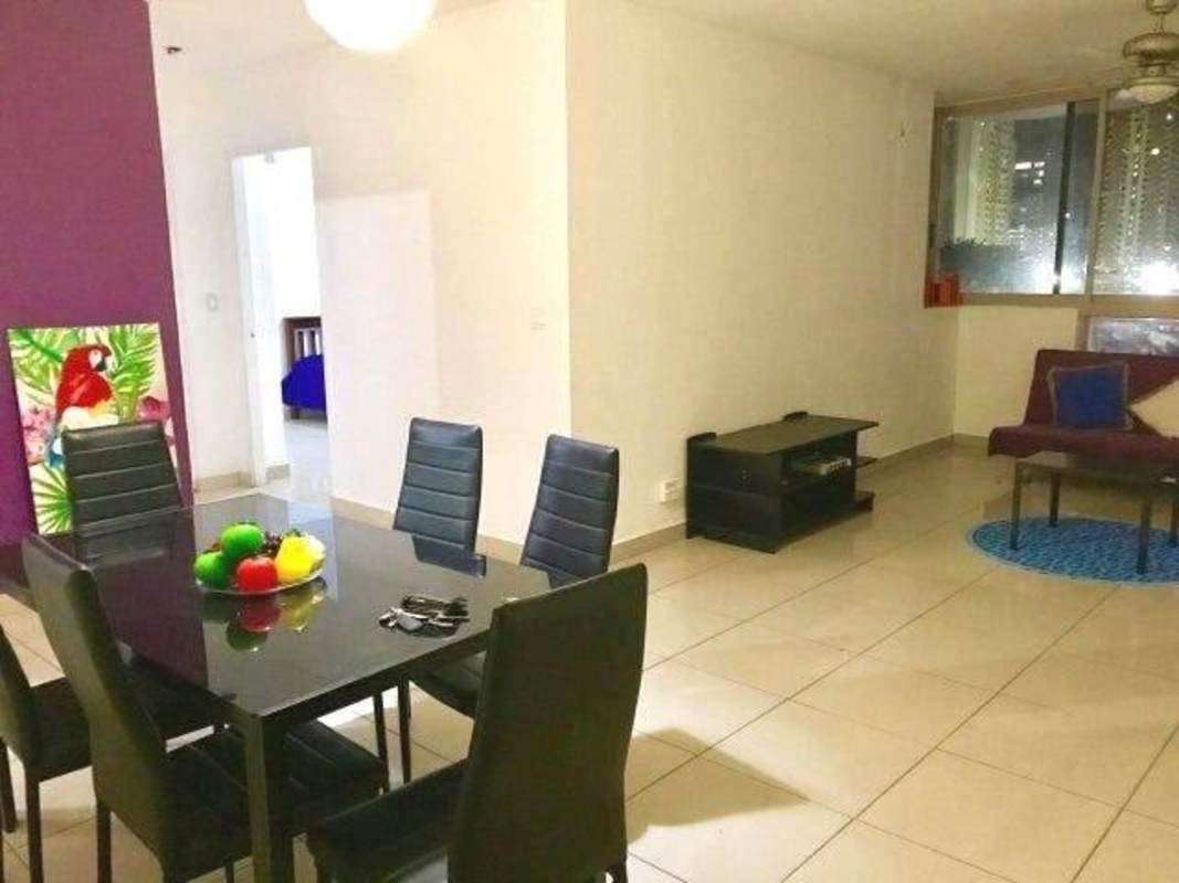 Dining area with purple accent wall and living room in PH San Francisco Bay Panama City