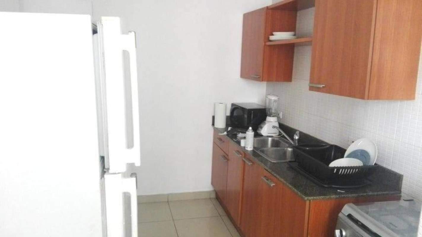 Fully equipped kitchen granite counters wood cabinets in PH San Francisco Bay Panama City