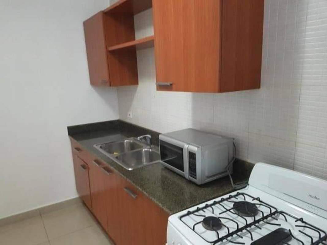 Kitchen with granite countertop, wood cabinets and appliances in PH San Francisco Bay Panama