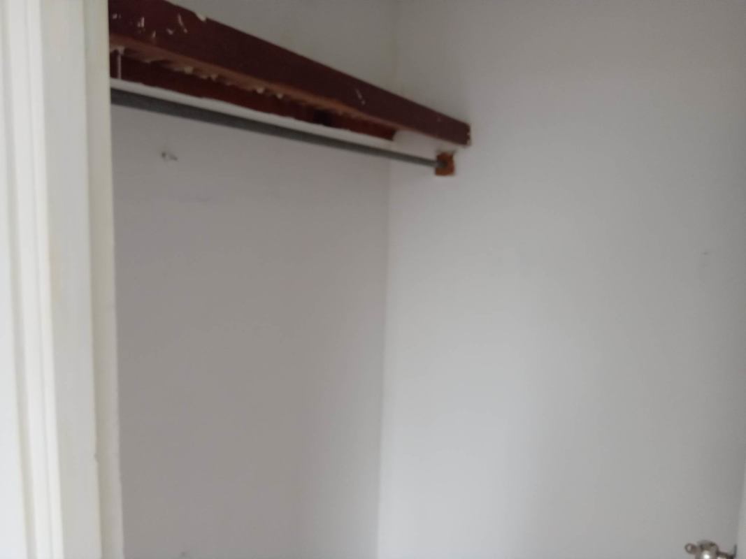 Empty closet with wooden shelf and rod PH Villa de las Fuentes Panama