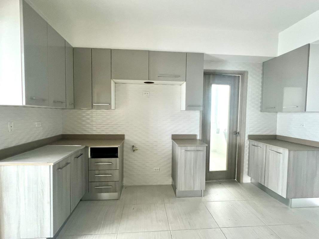 Spacious living and dining room with large windows and terrace access PH The Towers San Francisco Panama City