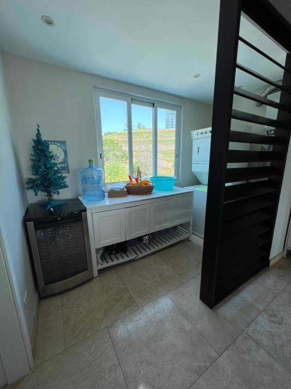 Bright open living room with marble floor, modern furnishings, balcony ocean views Bijao Beach Club Panama