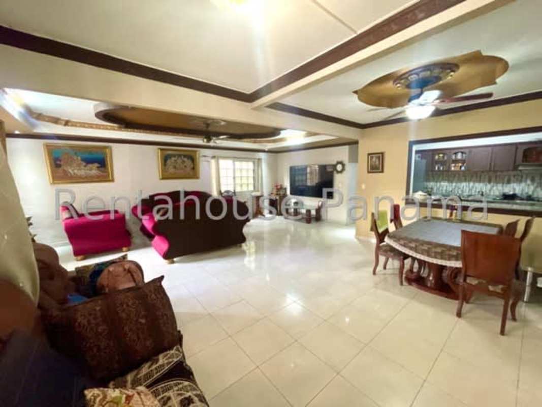 Open concept living dining room with tiled floors, ceiling fans and windows in house for sale Altos de Panamá