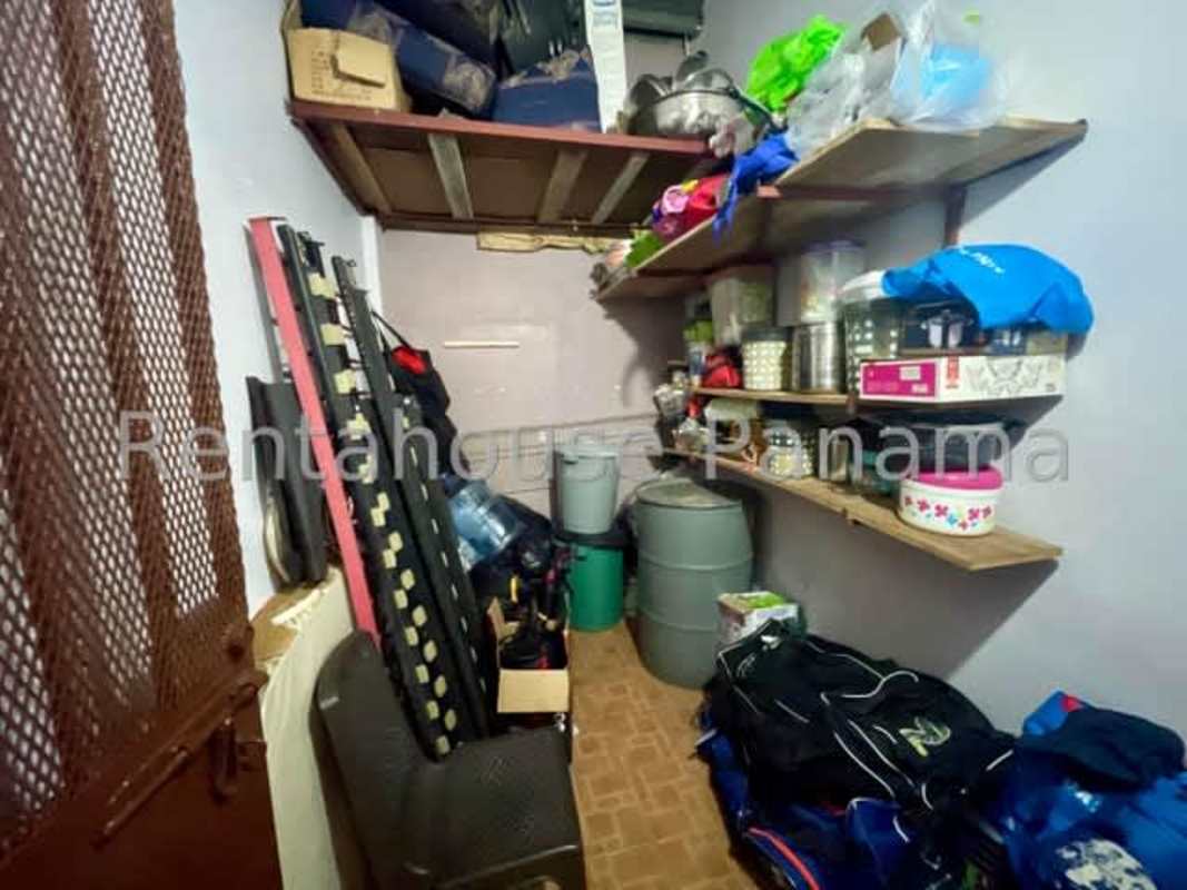 Exterior terrace with tile flooring, swing bench and green area in Altos de Panamá house sale