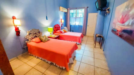 Traditional entry hall with bright walls, arched doorway, vibrant decor Coronado beach house
