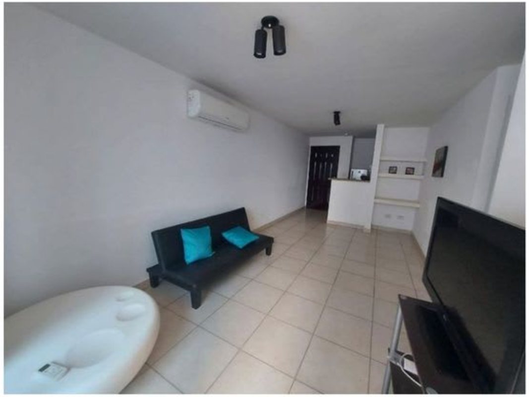 Modern minimalist apartment with living area and porcelain tile floors near Parque Omar Panama City