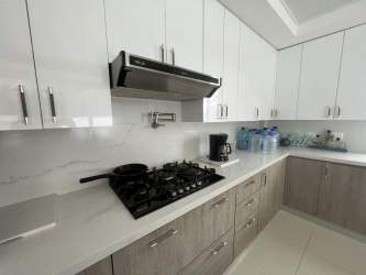 Bright kitchen with appliances, wood cabinets in beachfront residence Palenque Colon Panama