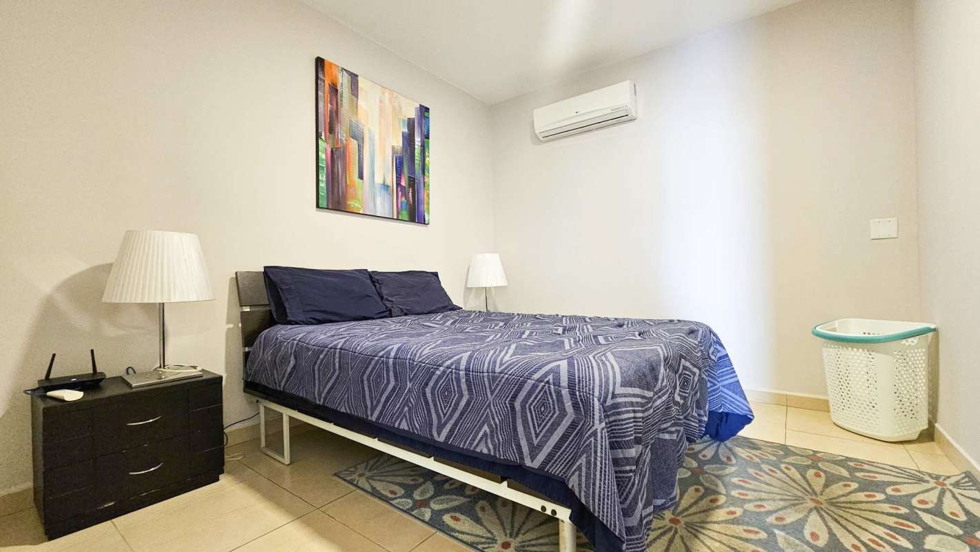 Modern master bedroom with large window ocean view, ensuite bathroom in PH BICSA Tower Panama City