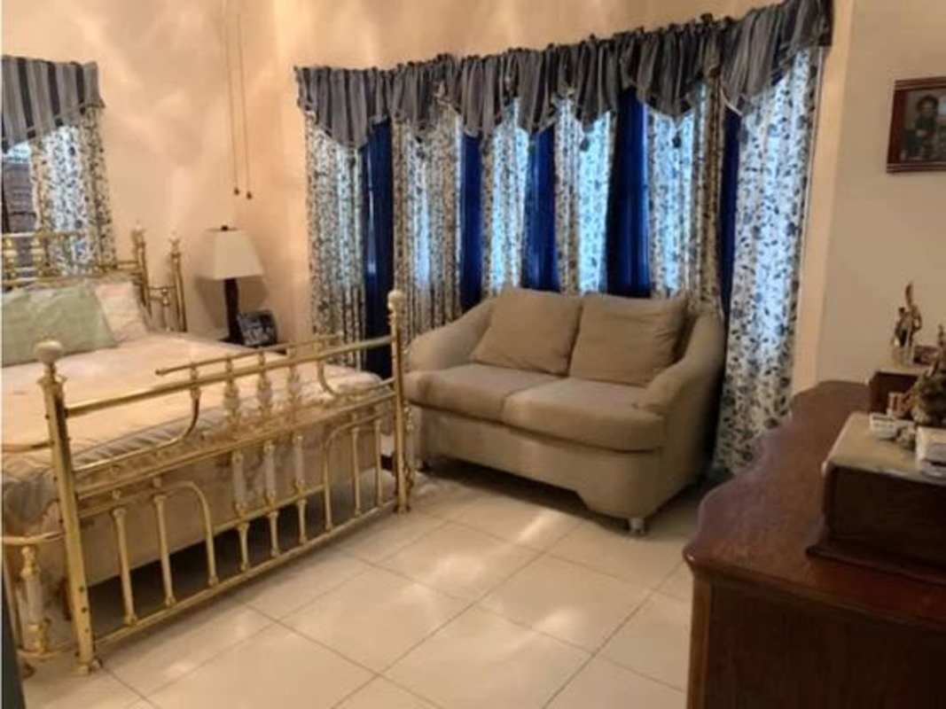 Kitchen with granite countertops, ceramic backsplash, ample cabinet space in Costa Sur Panama home