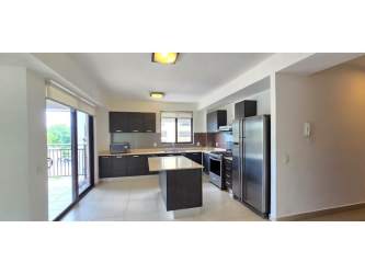Open living area with kitchen island and sliding glass doors PH River Valley Panama Pacifico