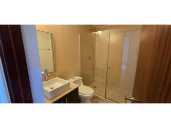 Bathroom with vessel sink, glass shower, modern tiles PH River Valley Panama Pacifico