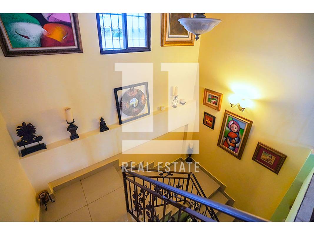 Interior hallway staircase with decorative rail and artwork Altos del Golf Panama house