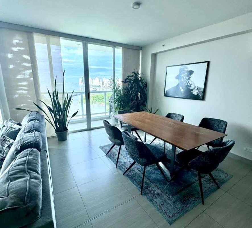 Modern open living dining featuring city and ocean views through floor-to-ceiling windows in PH Asia Costa del Este Panama