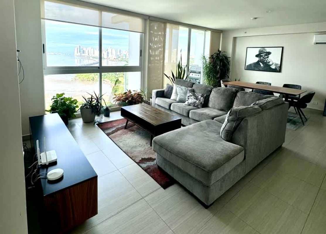 Living room with panoramic window offering city skyline in PH Asia Costa del Este