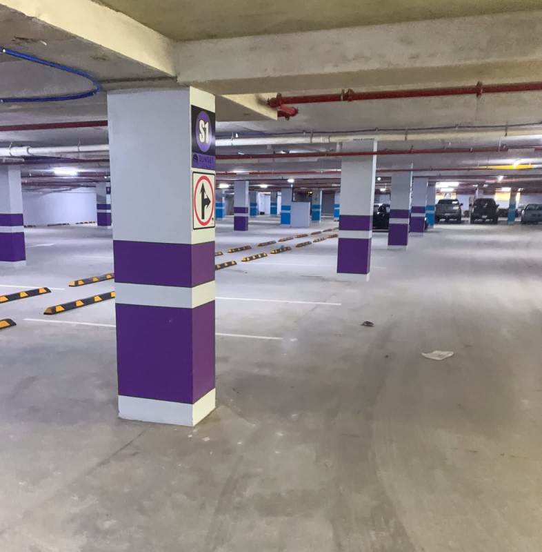 Multiple parking spaces underground with pillar markers underground garage sunset strip mall panama