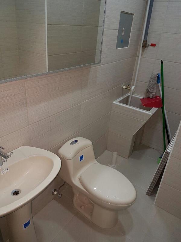 Compact bathroom with ceramic sink toilet and utility wash basin in medical office Brisas del Golf Panama