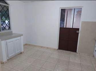 Bedroom with built-in closet and tiled floor in affordable house Panama