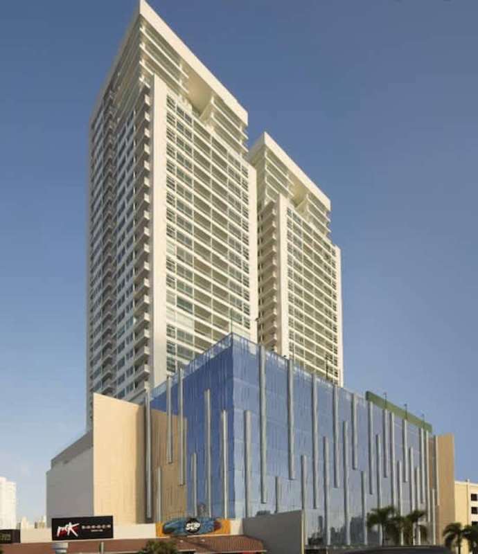 Modern twin-tower facade of PH The Towers with street-level retail in Panama City