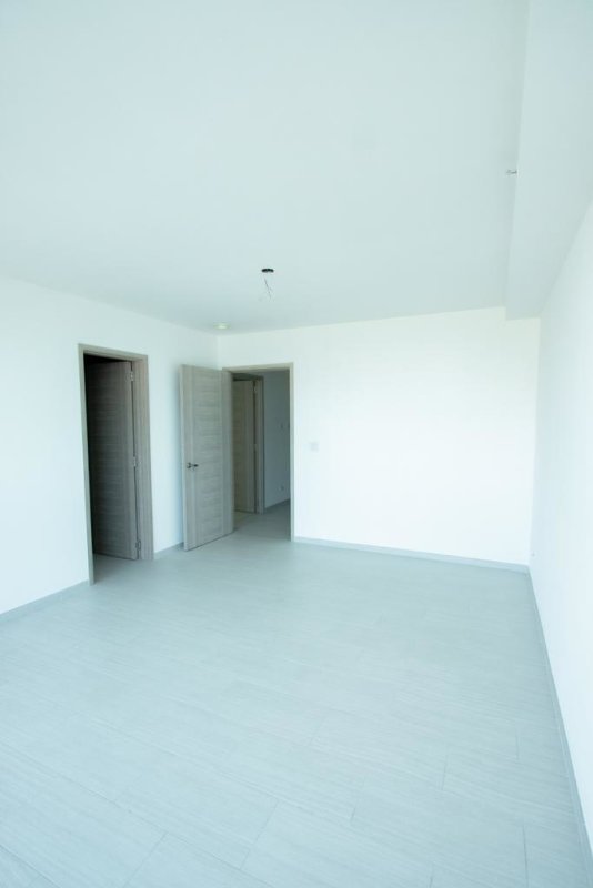 Spacious empty room with tiled flooring white walls PH The Towers Panama City