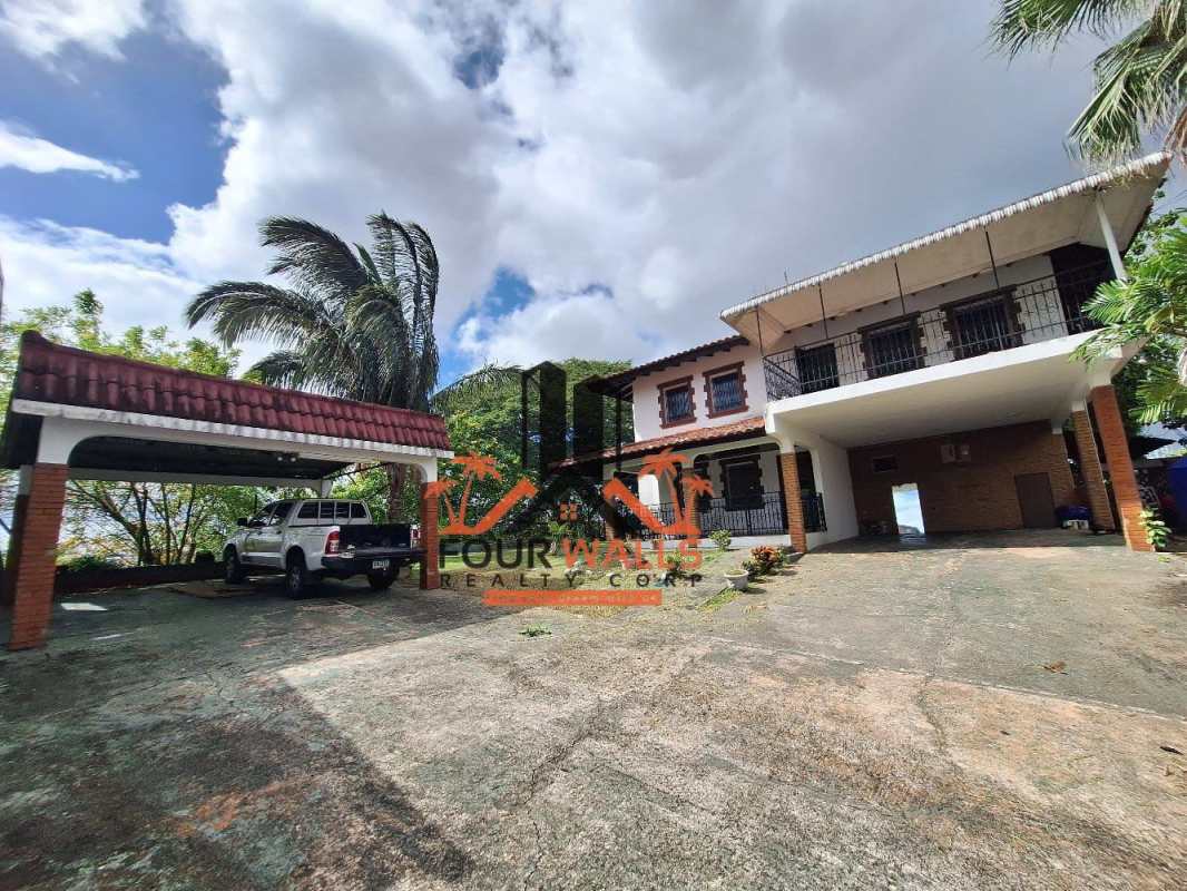Traditional kitchen with granite countertops, dark wood cabinets, stainless steel appliances in Villa de las Fuentes Panama