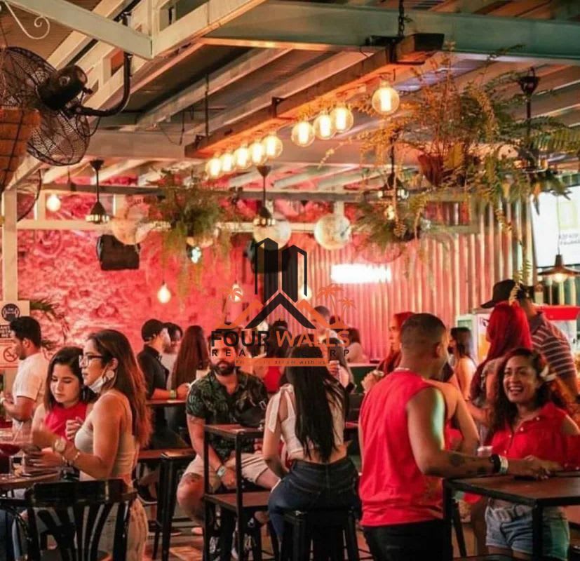 Restaurant bar with industrial design, plants, metal ceiling and people socializing Casco Viejo Panama