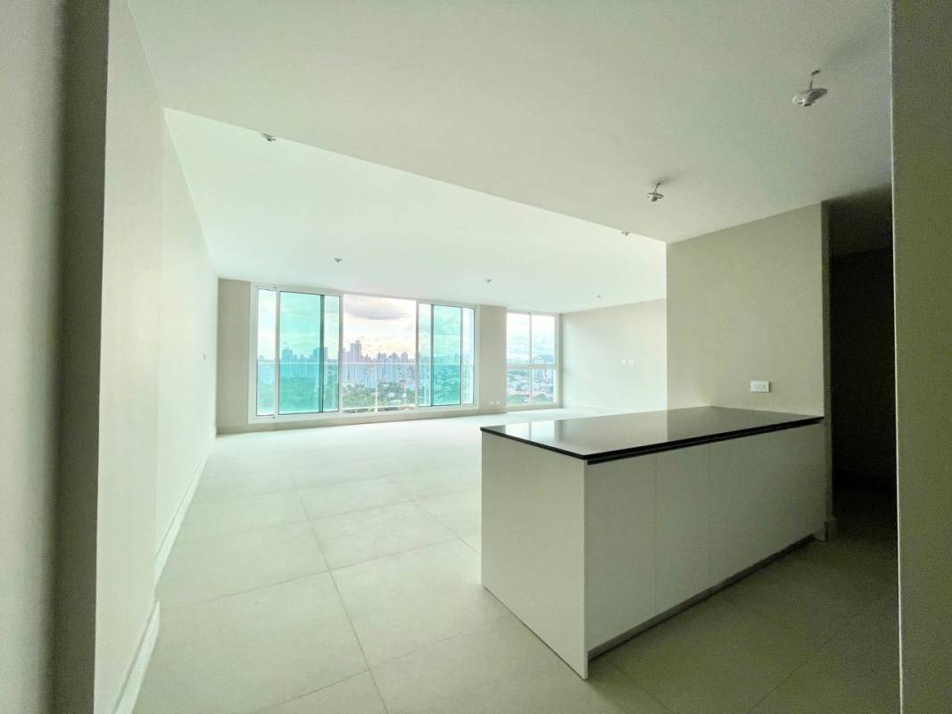 Spacious open-plan living and dining room with city skyline views at PH Riviera del Golf Panama City