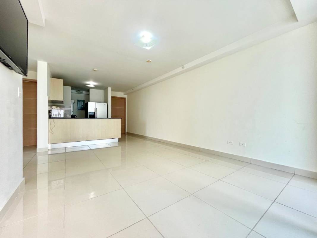 Open-plan living and dining area with tile floors and balcony in PH Torres de Castilla Panama