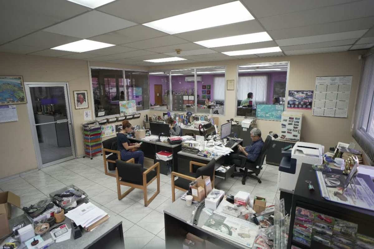 Open plan workspace with multiple desks and glass walls commercial building Betania Panama