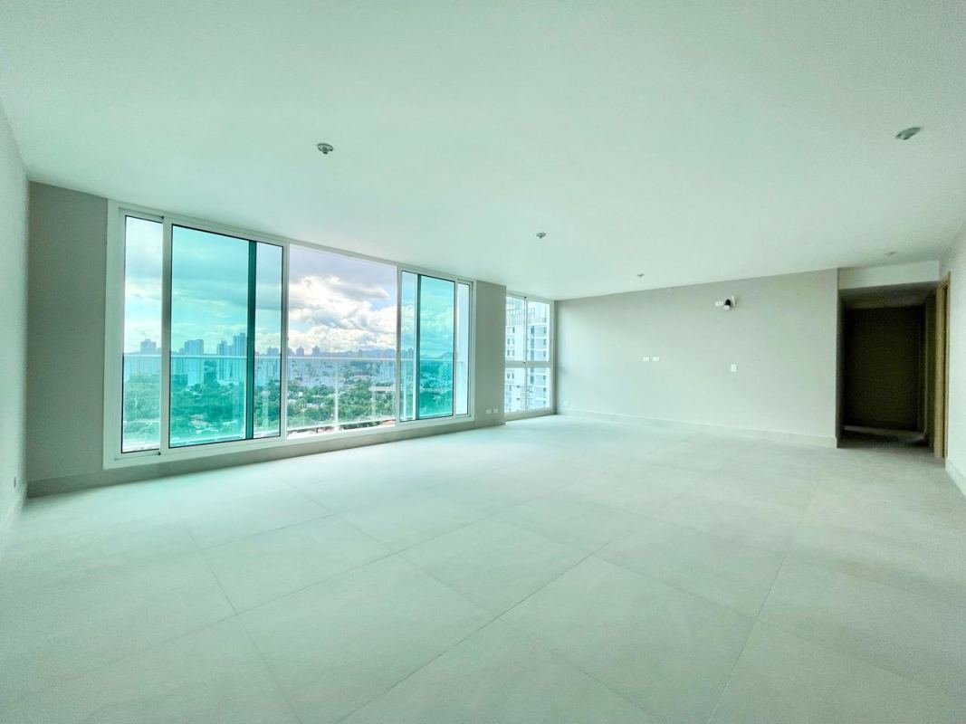 Bright empty living room with floor-to-ceiling windows and panoramic view at PH Riviera del Golf Panama City
