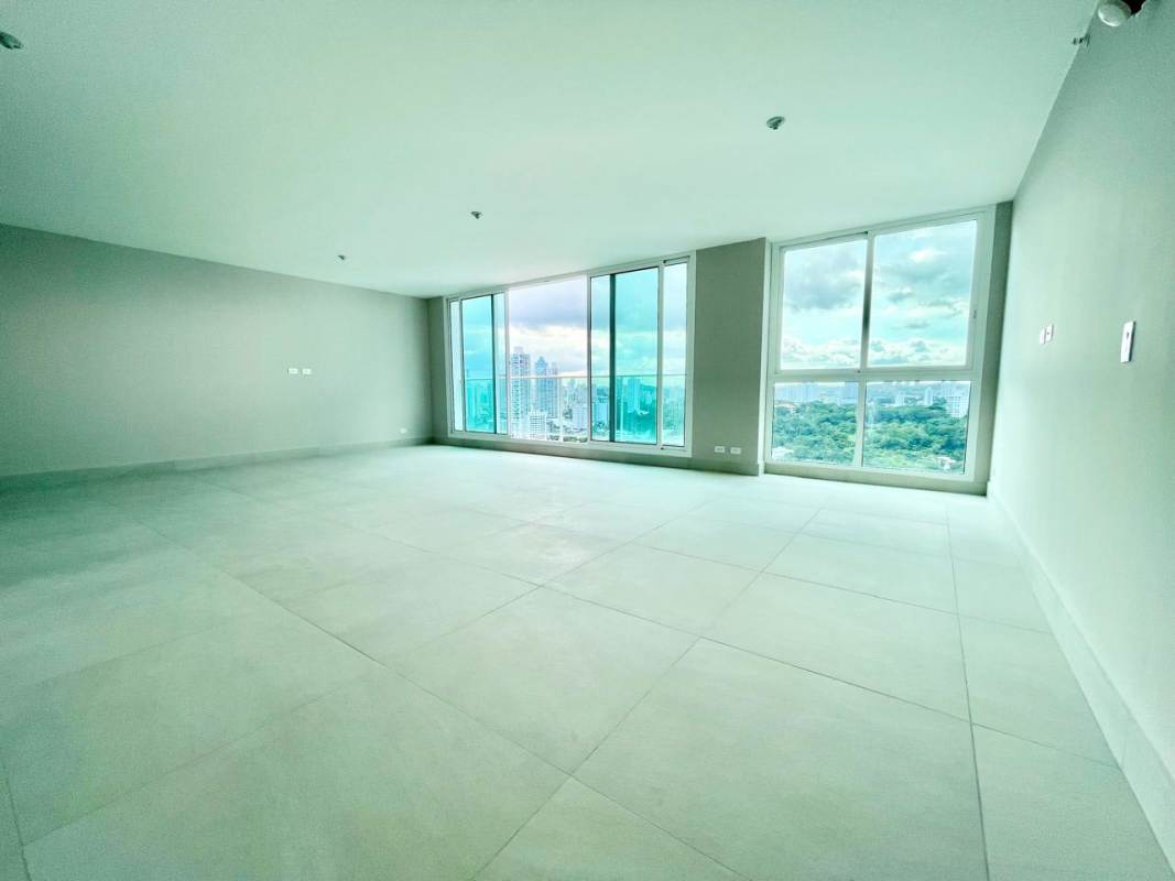 Spacious open living/dining area with floor-to-ceiling windows and city views at PH Riviera del Golf Panama City