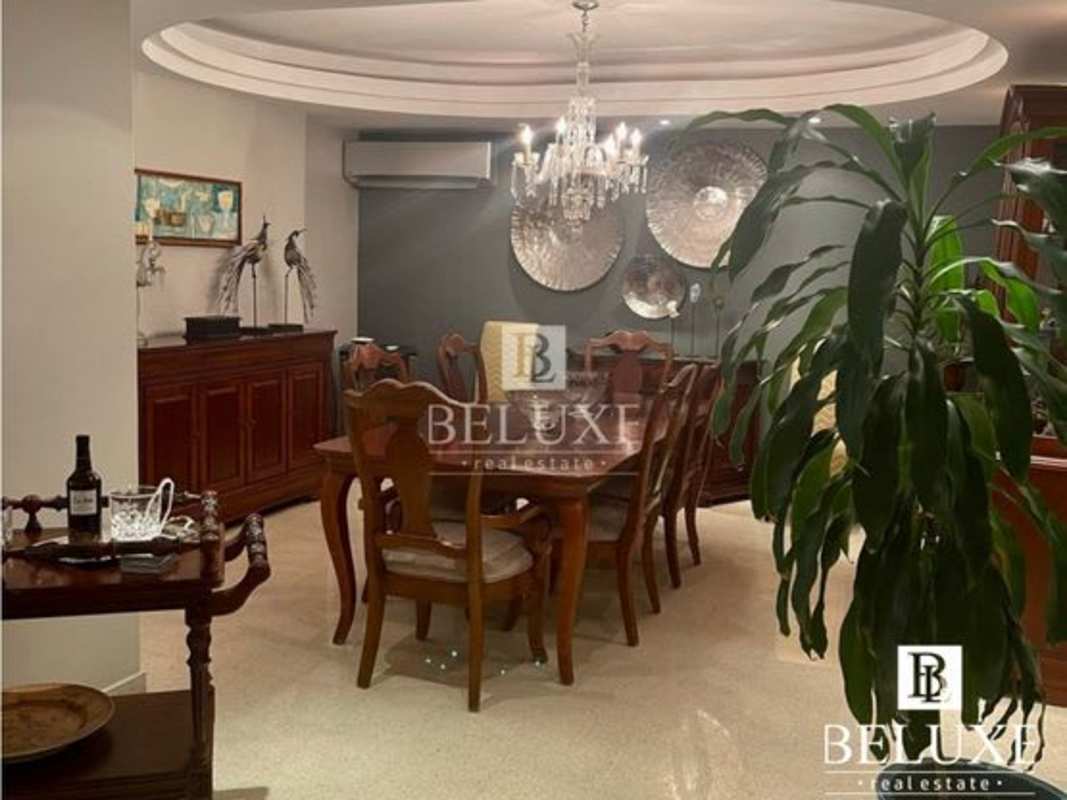 Traditional dining area with ornate chandelier, marble floor, and classic furnishings in Torre La Cresta Panama City