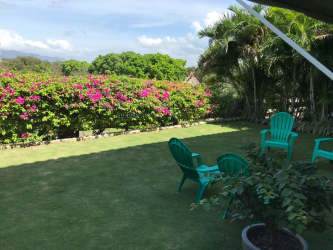Lush tropical garden and mountain views at Punta Barco Village beach condo complex Panama