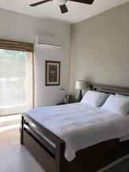 Contemporary spacious bedroom with garden view ceiling fan and AC Punta Barco Village Panama