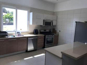 Bright modern kitchen with granite counters stainless steel appliances Punta Barco Village Panama