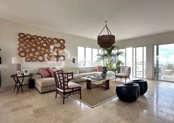 Open-plan living room with large windows, coastal decor, ocean views in Buenaventura penthouse