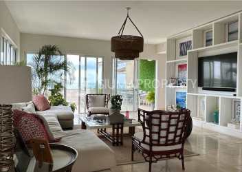 Spacious covered oceanfront balcony with lounge set and panoramic beach views Buenaventura