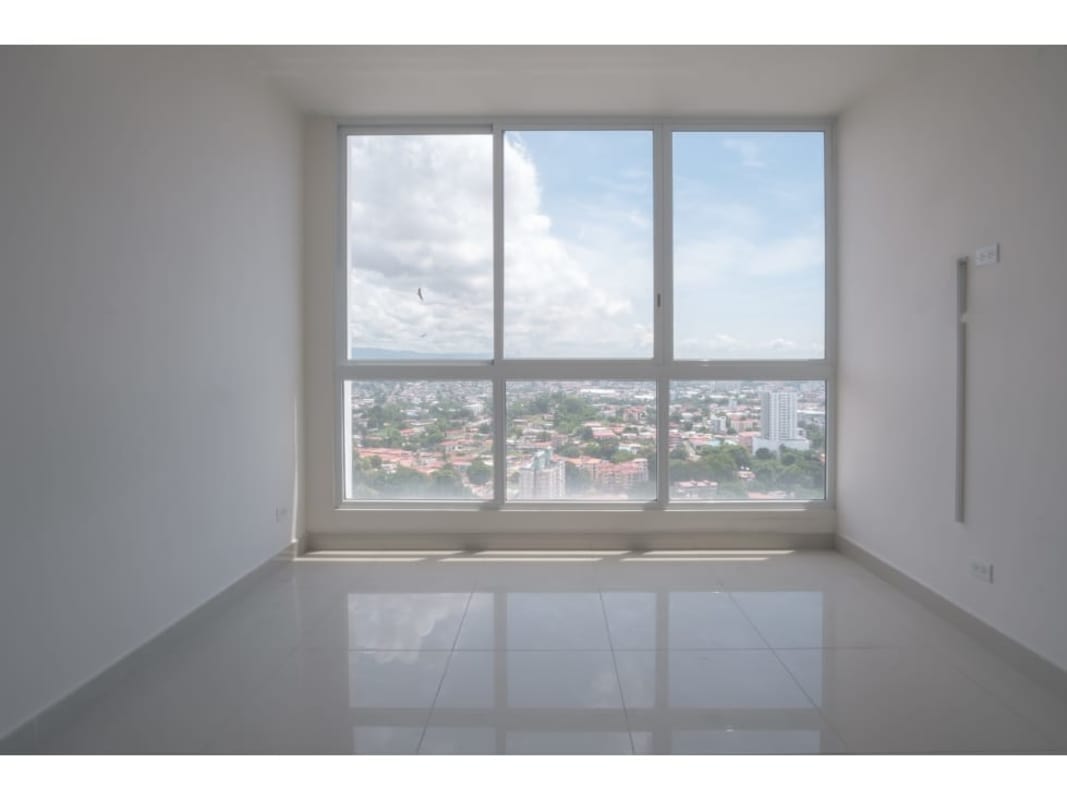 Minimalist bedroom with built-in wardrobe and white ceramic tile flooring in PH Victoria Royale Panama City