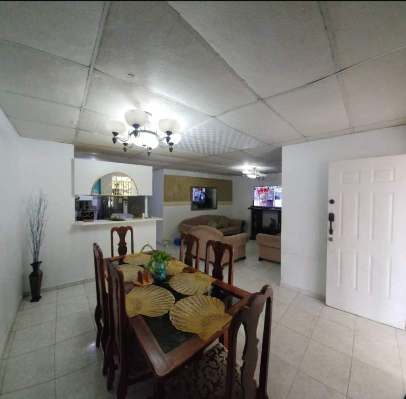 Bright bedroom single bed tiled floor accent wall window Cerro Viento house Panama