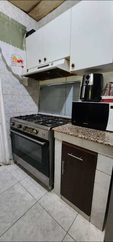 Open living dining area with tiled floors chandelier furniture Cerro Viento home
