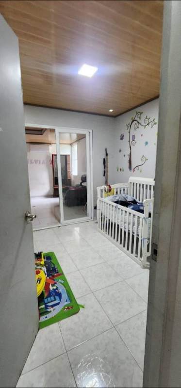 Bedroom with AC, yellow wall, built-in closet, tile floors Panama home