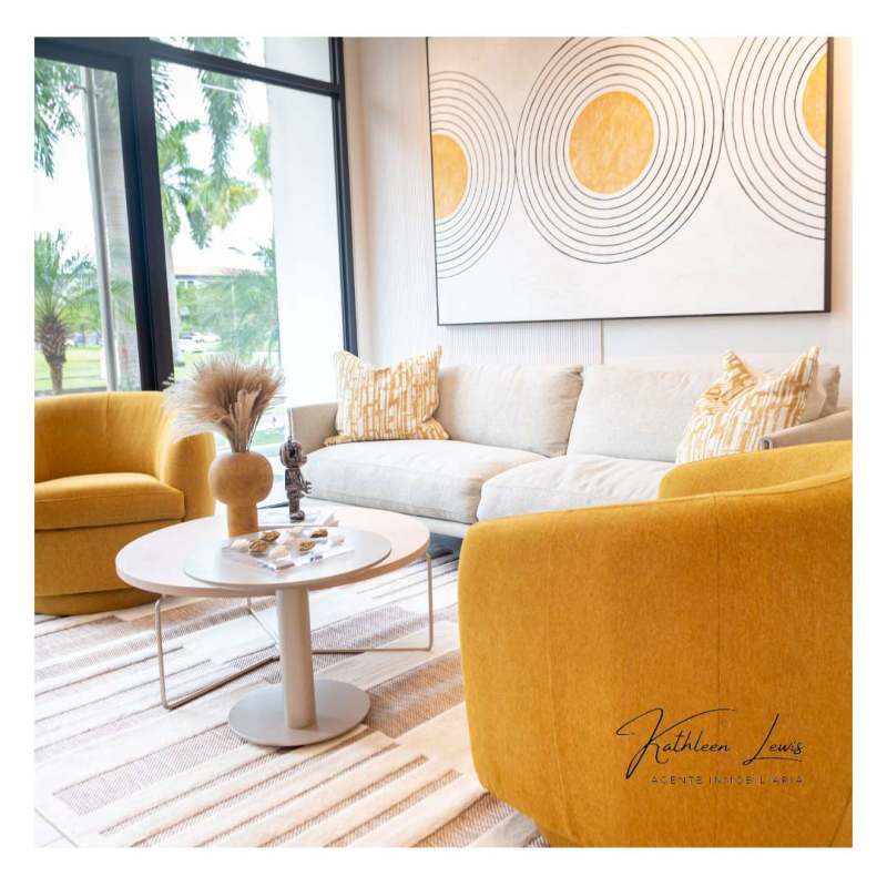 Bright living room with large windows, modern furniture, and skyline views at PH Nogal Costa del Este Panama